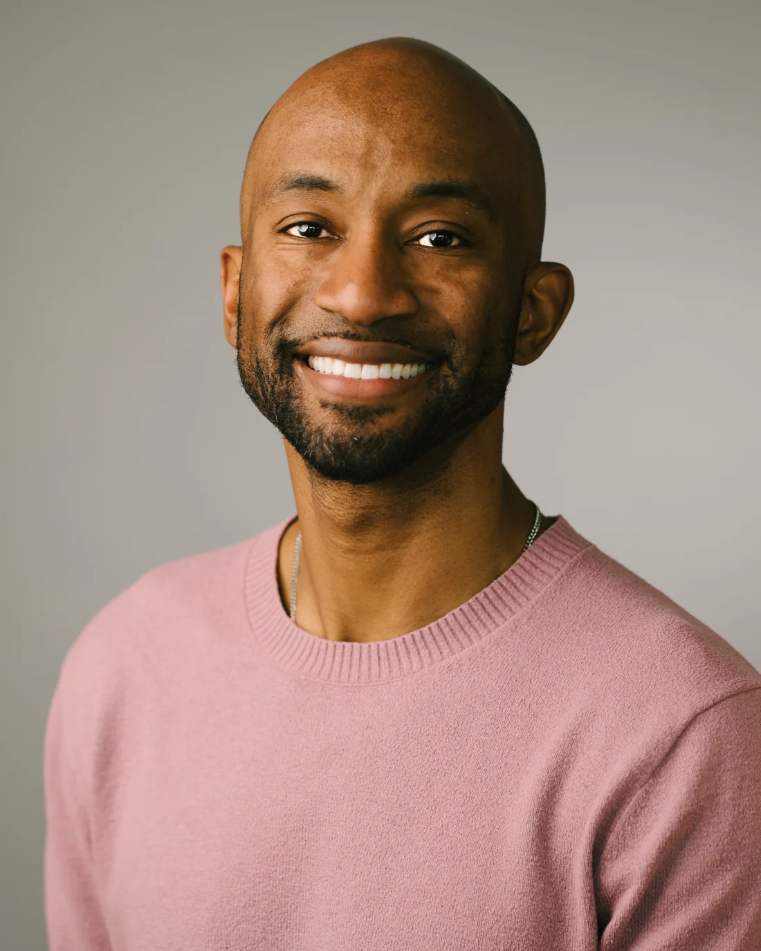 Emmanuel Aouad smiling in a studio portrait.